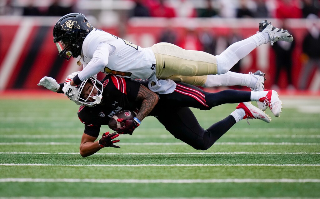 (Bethany Baker  |  The Salt Lake Tribune) Utah Utes wide receiver Mikey Matthews (0) is tackled by Colorado Buffaloes safety Shilo Sanders (21) at Rice-Eccles Stadium in Salt Lake City on Saturday, Nov. 25, 2023.