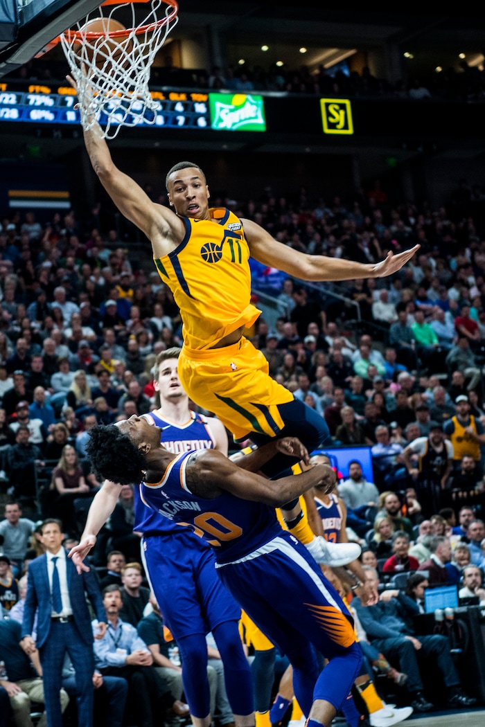 (Chris Detrick  |  The Salt Lake Tribune)  Utah Jazz guard Dante Exum (11) fouls Phoenix Suns guard Josh Jackson (20) during the game at Vivint Smart Home Arena Thursday, March 15, 2018. Utah Jazz defeated Phoenix Suns 116-88.