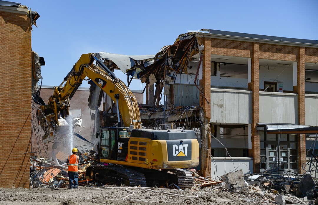 (Francisco Kjolseth  |  The Salt Lake Tribune)  Work begins tearing down the old West Jordan Middle School, 7550 S. Redwood Road, the oldest school in the Jordan School District on Tuesday, July 16, 2019.