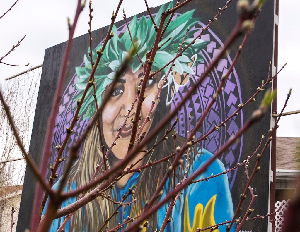 (Leah Hogsten | The Salt Lake Tribune) The Og-woi People's Orchard and Garden, built in May 2020, is located along the Jordan River in the Fairpark neighborhood, April 14, 2023. The garden's mural, center, memorializes Margarita Satini, a community organizer who died from COVID-19 in 2020. The city had told the Og-woi group that they'd have to take the mural down.