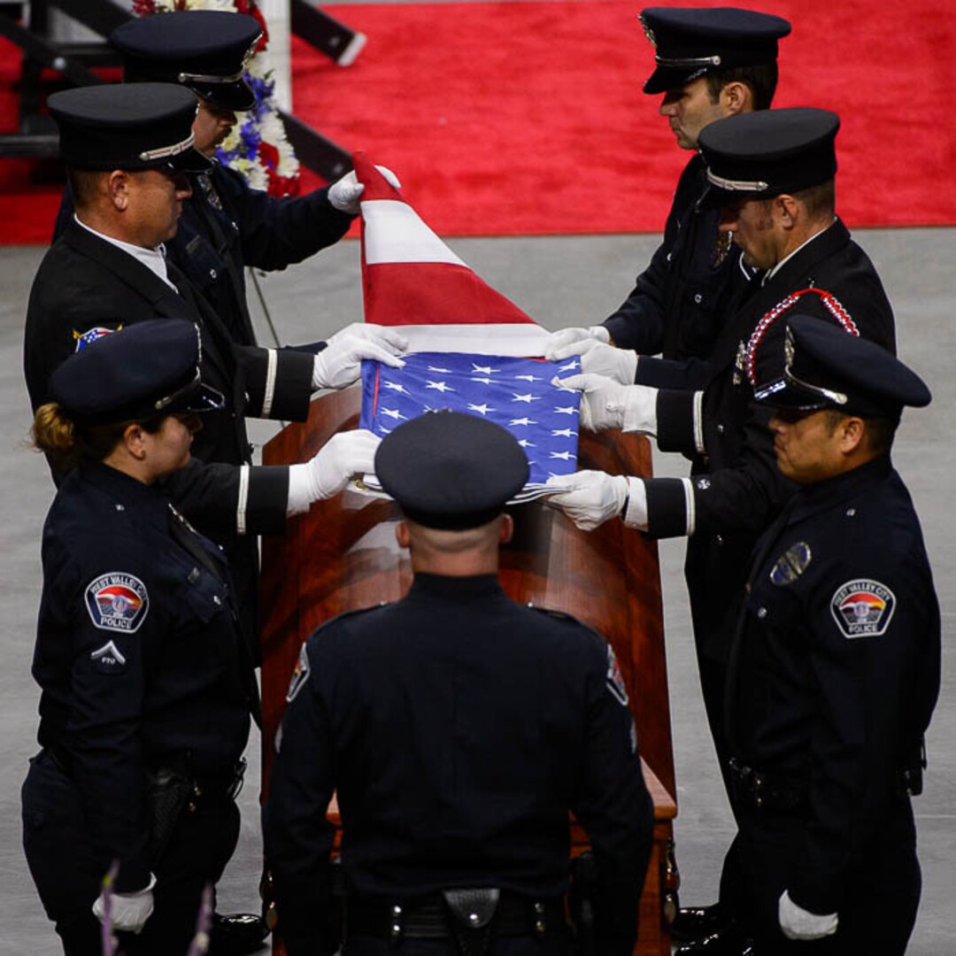 (Trent Nelson | The Salt Lake Tribune)  West Valley City police officers perform a flag presentation for family members at funeral services for Jill Robinson, a West Valley City code-enforcement officer killed on the job last week. The service took place at the Maverik Center in West Valley City on Friday Aug. 17, 2018.