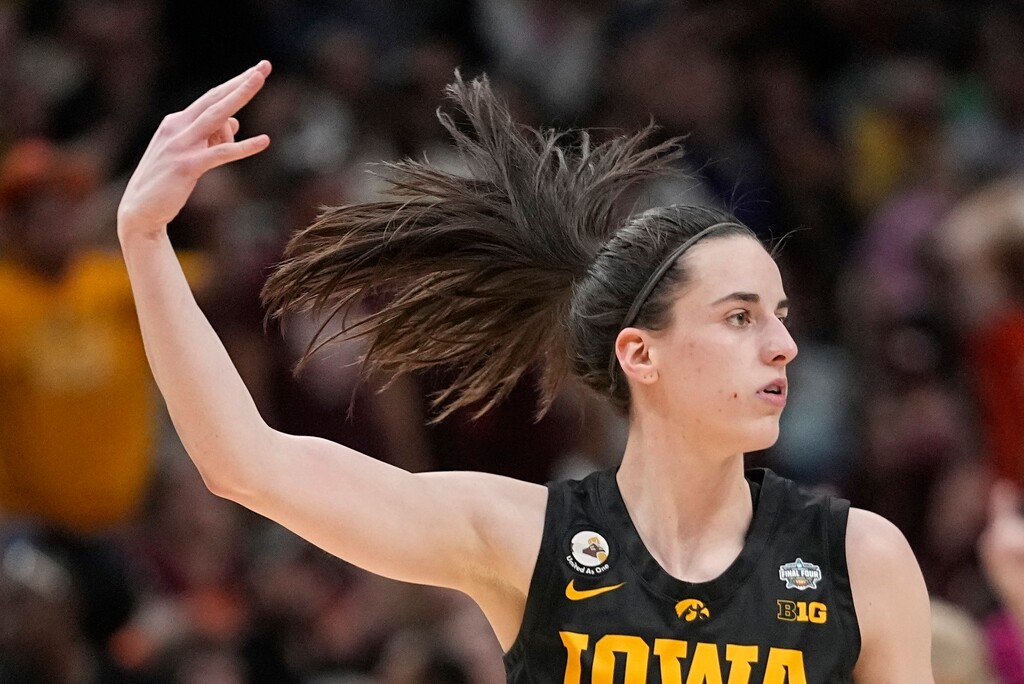 (AP Photo/Darron Cummings) Iowa's Caitlin Clark reacts after a three pointer during the second half of an NCAA Women's Final Four semifinals basketball game against South Carolina Friday, March 31, 2023, in Dallas.