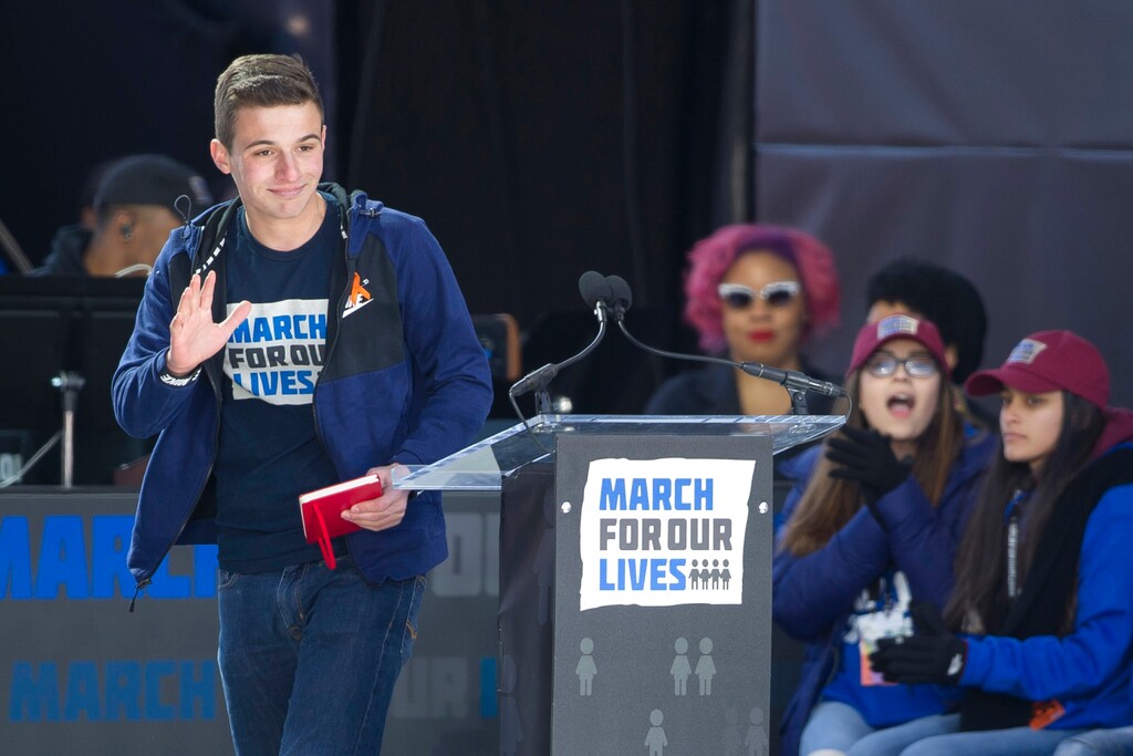 Cameron Kasky, a survivor of the mass shooting at Marjory Stoneman Douglas High School in Parkland, Fla., waves after speaking at the March for Our Lives rally in support of gun control in Washington, Saturday, March 24, 2018, on Pennsylvania Avenue near the U.S. Capitol in Washington. (AP Photo/Cliff Owen)