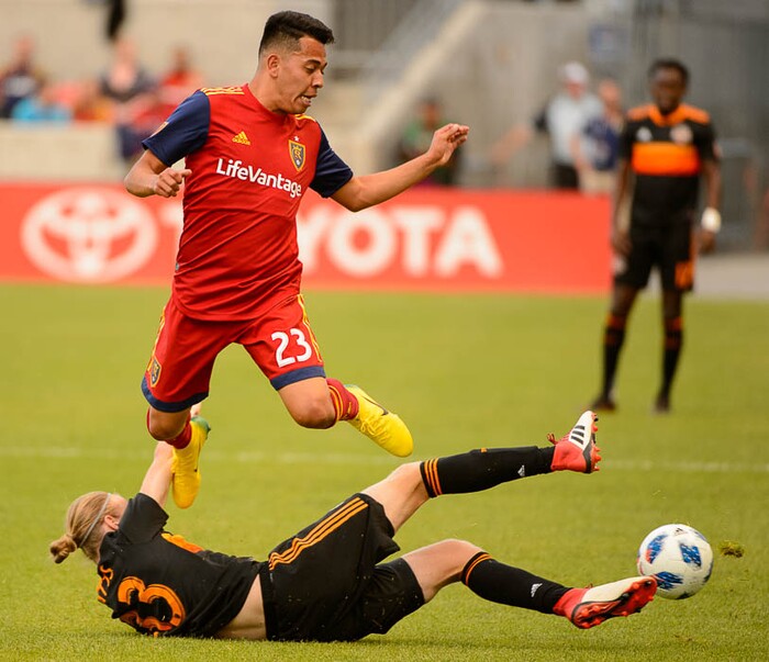 (Trent Nelson | The Salt Lake Tribune)  
Real Salt Lake midfielder Sebastian Saucedo (23) leaps over Houston's Jared Watts (33) as Real Salt Lake hosts Houston Dynamo, MLS Soccer at Rio Tinto Stadium in Sandy, Utah, Wednesday May 30, 2018.