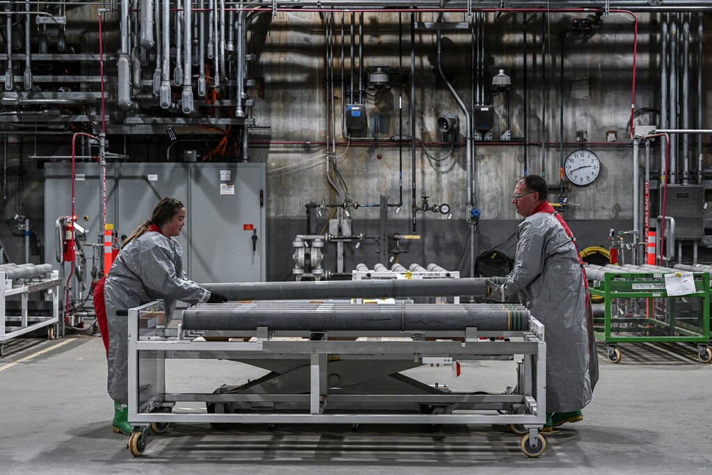 (Kenny Holston | The New York Times) Munitions operators Amira VanDall, left, and Shane Hurt working at the Blue Grass Army Depot in Richmond, Ky., June 22, 2023. Decades behind its initial schedule, the dangerous job of eliminating the world’s only remaining declared stockpile of lethal chemical munitions will be completed soon.