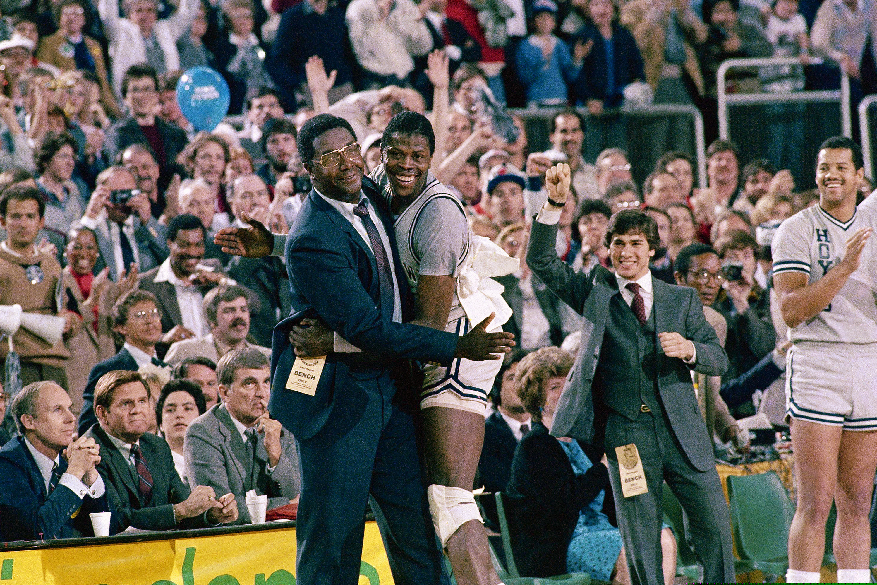 (AP Photo) In this April 2, 1984, file photo, Georgetown head coach John Thompson, left, gives a happy pat to the most valuable player Patrick Ewing, after Georgetown defeated Houston 84-75 in Seattle. John Thompson, the imposing Hall of Famer who turned Georgetown into a “Hoya Paranoia” powerhouse and became the first Black coach to lead a team to the NCAA men’s basketball championship, has died. He was 78 His death was announced in a family statement Monday., Aug. 31, 2020.