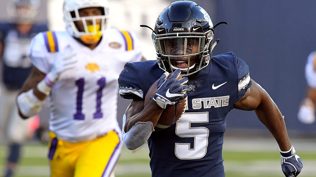Utah State running back Darwin Thompson (5) carries the ball for a 65-yard touchdown as Tennessee Tech defensive back A.J. Flemister (11) defends during an NCAA college football game, Thursday, Sept. 13, 2018, in Logan, Utah. (Eli Lucero/Herald Journal via AP)