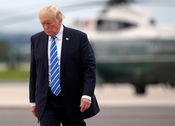 President Donald Trump walks across the tarmac before boarding Air Force One at Hagerstown Regional Airport, Aug. 18, 2017, in Hagerstown, Md. Trump is returning to Bedminster N.J., after having a meeting with his national security team at Camp David, Md. (AP Photo/Pablo Martinez Monsivais)