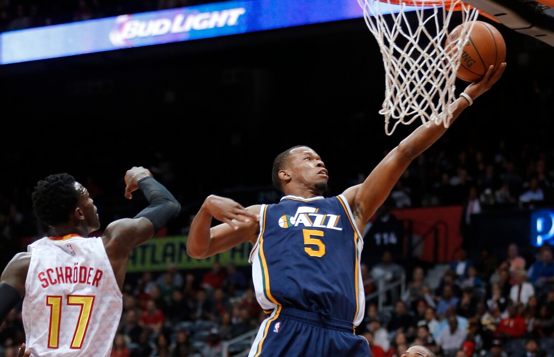 Utah Jazz guard Rodney Hood (5) goes up for a shot against Atlanta Hawks guard Dennis Schroeder (17) during the first half of an NBA basketball game Sunday, Nov. 15, 2015, in Atlanta. (AP Photo/John Bazemore)
