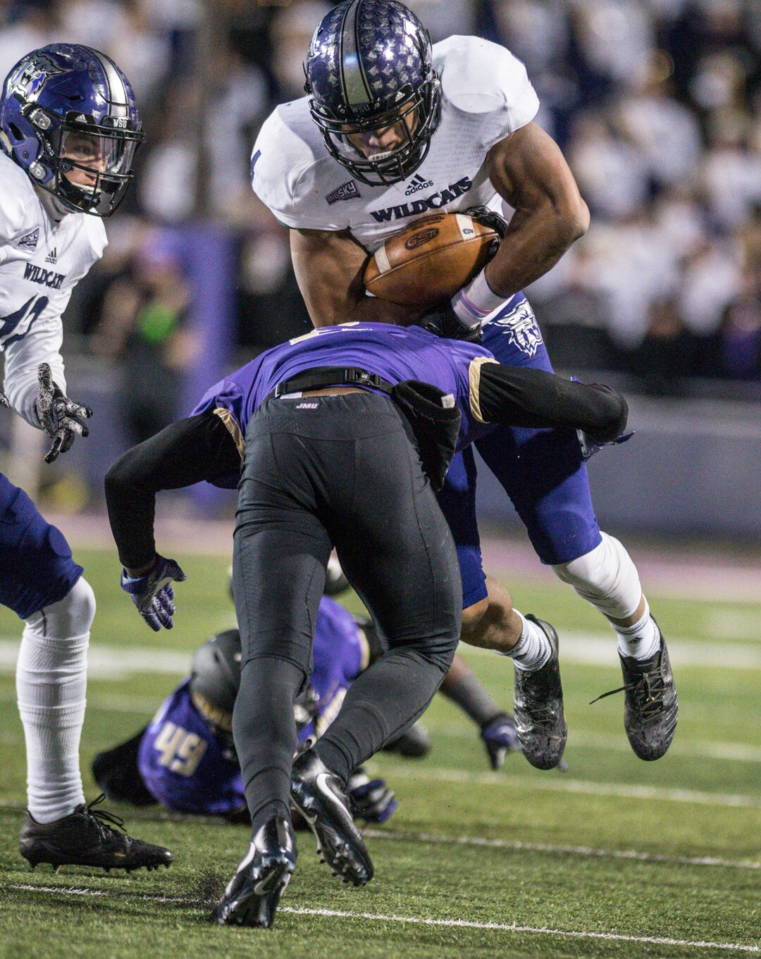 Weber State running back Kevin Smith (4) leaps as James Madison cornerback Jimmy Moreland (6) makes the tackle during the first half of an NCAA college football game in the quarterfinals of the FCS playoffs Friday, Dec. 8, 2017, in Harrisonburg, Va. (Daniel Lin/Daily News-Record via AP)