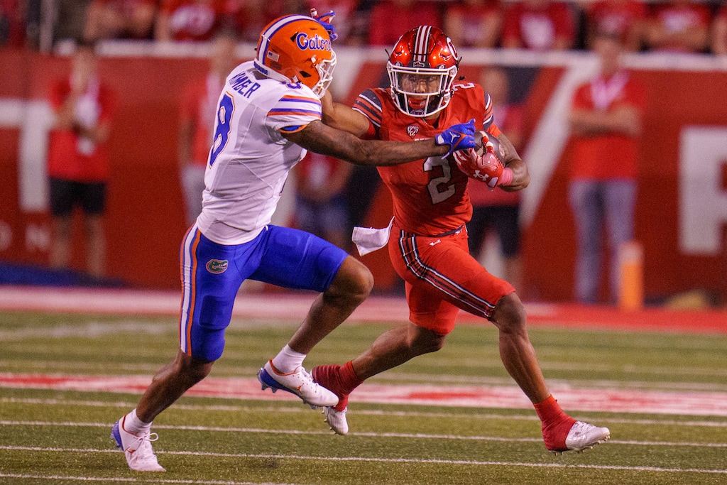 (Trent Nelson  |  The Salt Lake Tribune) Utah Utes running back Micah Bernard (2) runs the ball defended by Florida Gators cornerback Jalen Kimber (8) as the Utah Utes host the Florida Gators in Salt Lake City on Aug. 31, 2023.