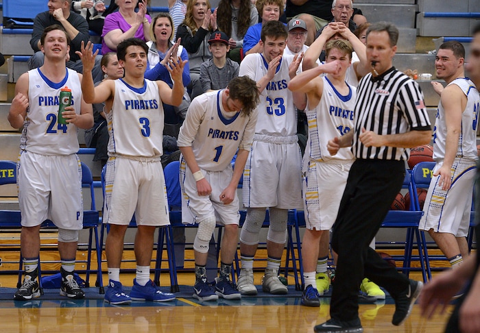 (Leah Hogsten | The Salt Lake Tribune) The starters react to the play of their teammates after they were replaced during the last minute of the game. Cyprus High School boys' basketball team defeated Hillcrest High School 77-61 during their game Tuesday, January 30, 2018 in Magna.