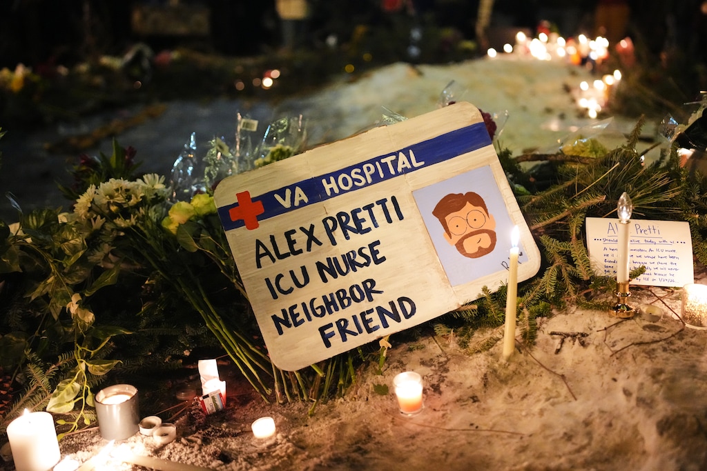 A sign for 37-year-old Alex Pretti, who was fatally shot by a U.S. Border Patrol officer earlier in the day, is displayed during a vigil Saturday, Jan. 24, 2026, in Minneapolis. (AP Photo/Adam Gray)