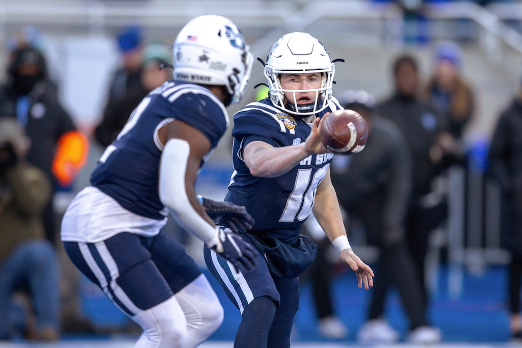 Utah State quarterback McCae Hillstead (10) pitches the ball to running back Robert Briggs Jr. (2) during the second half of the team's Famous Idaho Potato Bowl NCAA college football game against Georgia State, Saturday, Dec. 23, 2023, in Boise, Idaho. (AP Photo/Steve Conner)
