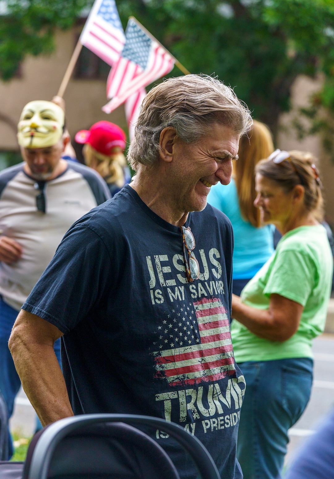 (Leah Hogsten | The Salt Lake Tribune) Protesters waving American flags and holding signs decrying mask and vaccine mandates gathered along the curb of 700 East in Liberty Park Saturday, making Salt Lake City one of dozens of cities around the world protesting public health-related restrictions, Sept. 18, 2021.