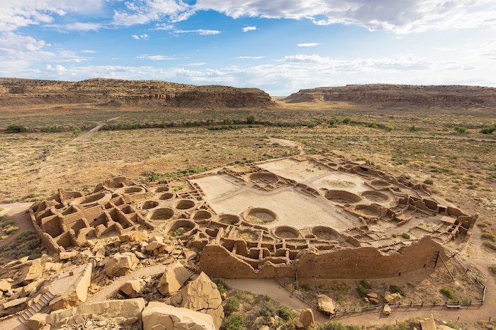 A view of Pueblo Bonito from the cliffs above, at the Chaco Culture National Historic Park in northwestern New Mexico, on Aug. 22, 2019. In the red rock desert of the Southwest, an ancient culture was thought to have vanished but a new view connects it to pueblo dwellers of today. (John Burcham/The New York Times)