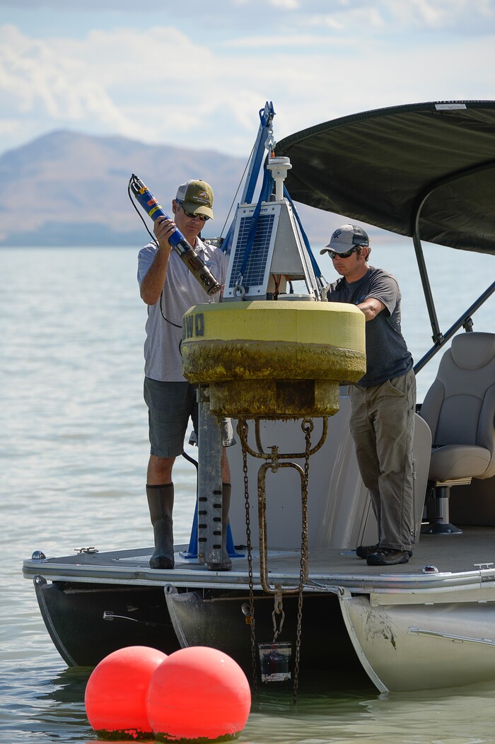 (Francisco Kjolseth | The Salt Lake Tribune) Marshall Baillie, left, and Ben Brown with the division of water quality attend to one of three Dip Test sensors in Utah Lake used for collecting data on. Members of the Legislative Water Development Commission take a tour of Utah Lake on Wednesday, Sept. 13, 2017, for the purpose of learning of wastewater treatment, the importance of protecting our lakes and rivers, how the state is looking to change water quality standards and how regulation is an important local issue.