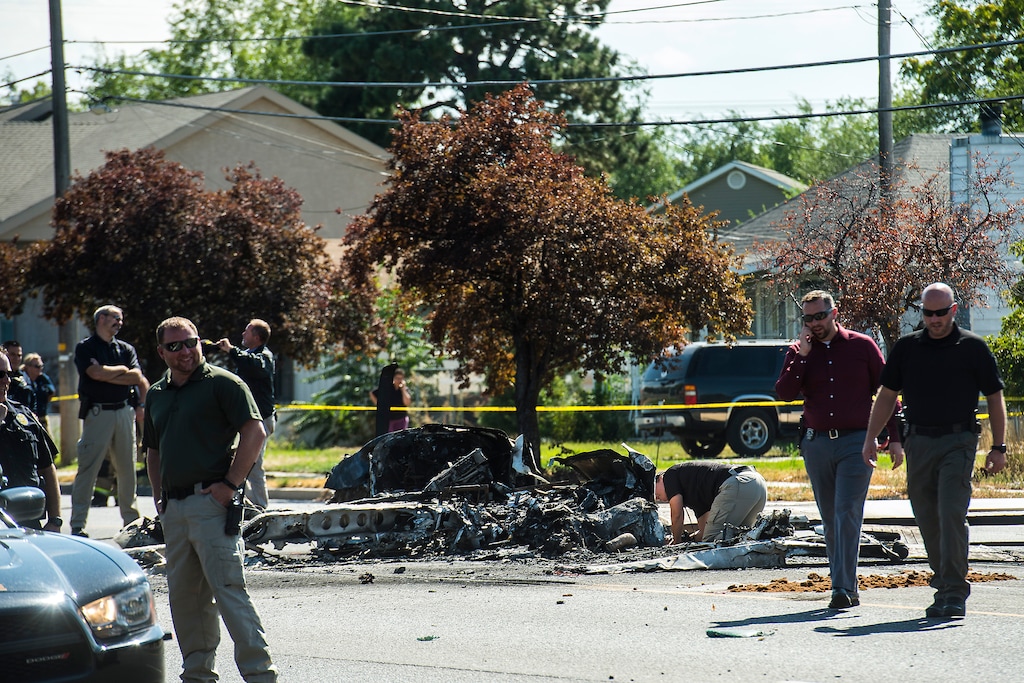 (Chris Detrick  |  The Salt Lake Tribune)  The scene of a plane crash at 1900 West and 4500 in Roy Tuesday, September 12, 2017. The pilot of a single-engine airplane survived a fiery crash on a street in Roy Tuesday afternoon, authorities said. Roy police Sgt. Matthew Gwynn said the pilot was transported to a hospital “out of precaution,” as was the driver of a car that the plane hit.