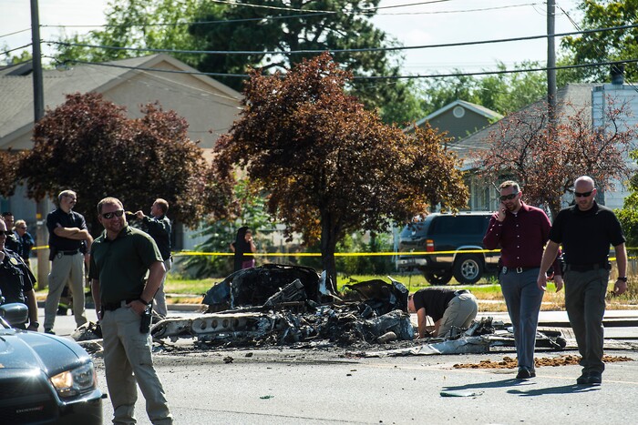 (Chris Detrick  |  The Salt Lake Tribune)  The scene of a plane crash at 1900 West and 4500 South  in Roy Tuesday, September 12, 2017. The pilot of a single-engine airplane survived a fiery crash on a street in Roy Tuesday afternoon, authorities said. Roy police Sgt. Matthew Gwynn said the pilot was transported to a hospital “out of precaution,” as was the driver of a car that the plane hit.