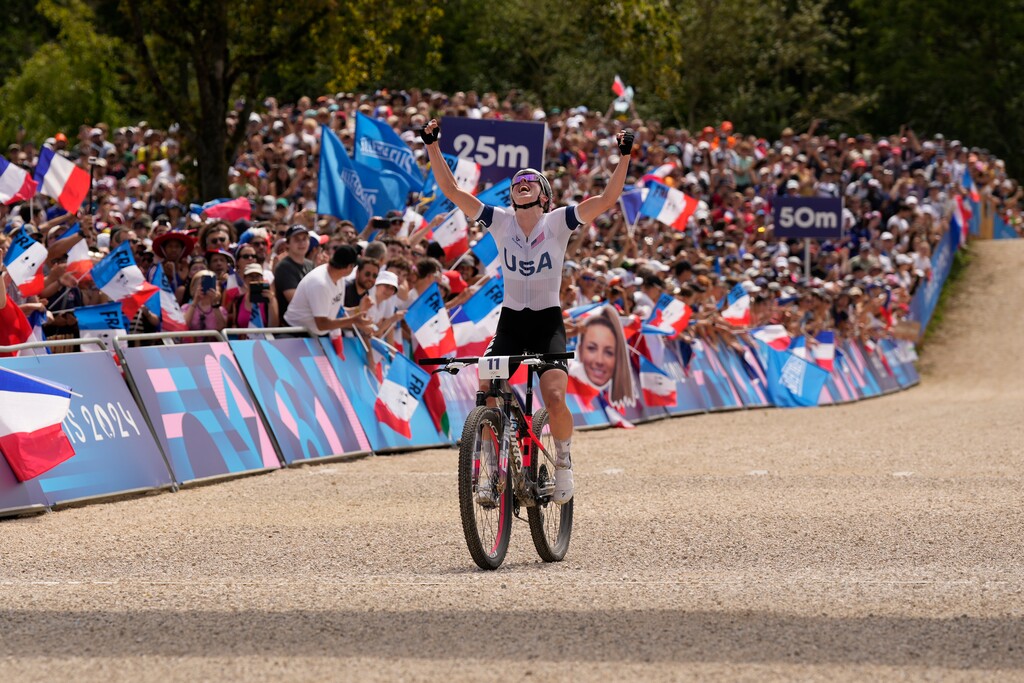 (George Walker IV | AP) Haley Batten, of United States, celebrates her second place in the women's mountain bike cycling event, at the 2024 Summer Olympics, Sunday, July 28, 2024, in Elancourt, France.