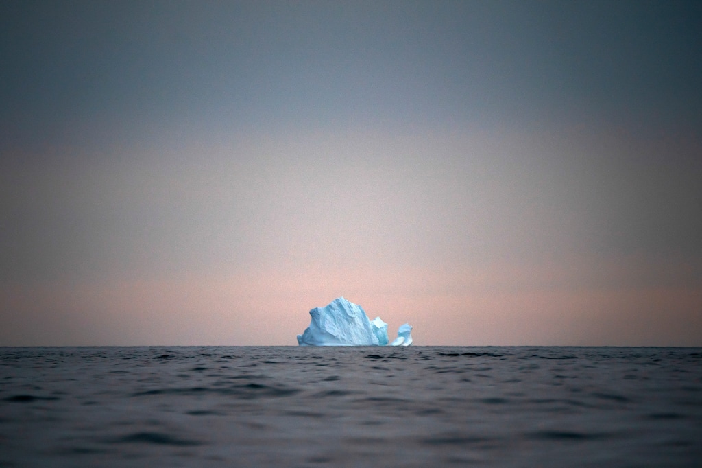 (Felipe Dana | AP Photo) In this Aug. 15, 2019, photo, a large Iceberg floats away as the sun sets near Kulusuk, Greenland. Greenland is where Earth's refrigerator door is left open, where glaciers dwindle and seas begin to rise. Scientists are hard at work there, trying to understand the alarmingly rapid melting of the ice.