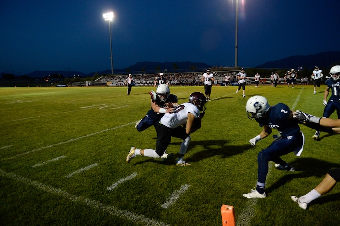 (Francisco Kjolseth  |  The Salt Lake Tribune)  Jordan quarterback Crew Wakley runs the ball into the end zone for a touchdown in the third quarter against Syracuse in game action at Syracuse on Thursday, Aug. 24, 2017.