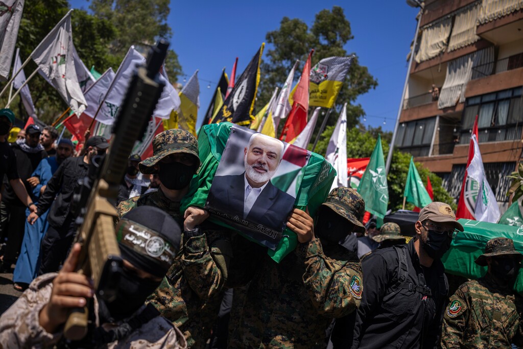 (Diego Ibarra Sanchez | The New York Times) Hamas supporters parade on Friday, Aug. 2, 2024, in Beirut, Lebanon, with empty coffins in a symbolic funeral for the Hamas leader Ismail Haniyeh.