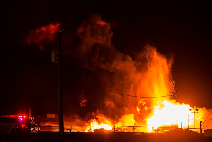 (Chris Detrick  |  The Salt Lake Tribune)  Firefighters attempt to put out a burning semitrailer that was hauling thousands of gallons of fuel on Interstate-15 in Midvale Thursday, January 18, 2018.   Lt. Todd Royce of the Utah Highway Patrol said the truck was southbound on the interstate at 7500 South at 7:20 p.m. when a tire caught fire, sending flames toward the tanks.