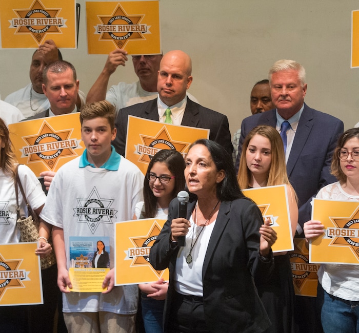(Rick Egan  |  The Salt Lake Tribune)  Rosie Rivera gives a second speech Saturday, Aug. 12, 2017, before the final vote for Salt Lake County sheriff. Fellow candidates Levi Hughes, Fred Ross, Ken Hansen — who lost in the previous round — hold signs supporting her.
