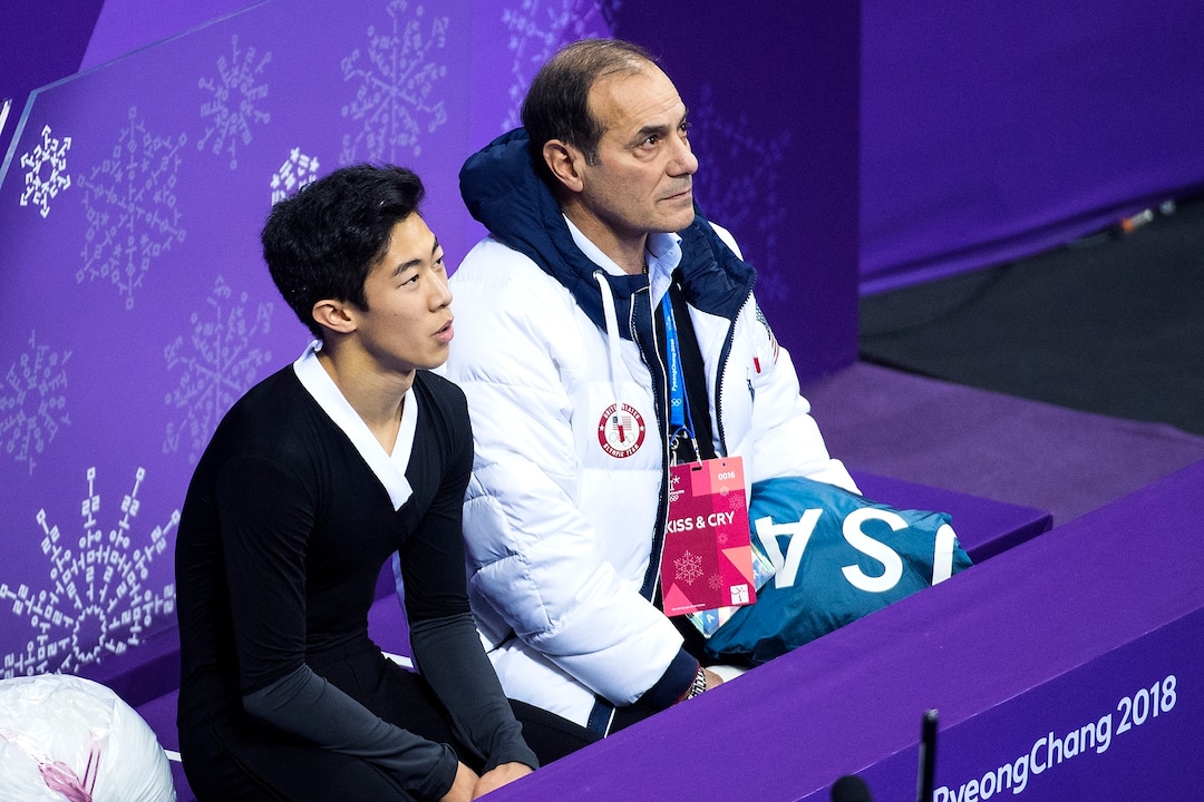 (Chris Detrick  |  The Salt Lake Tribune)  Salt Lake City's Nathan Chen and his coach Rafael Arutyunyan listen as Chen's score is announced in the Men Single Skating Free Skating at Gangneung Ice Arena during the Pyeongchang 2018 Winter Olympics Saturday, Feb. 17, 2018. Chen landed a record six quadruple jumps, scoring 215.08.