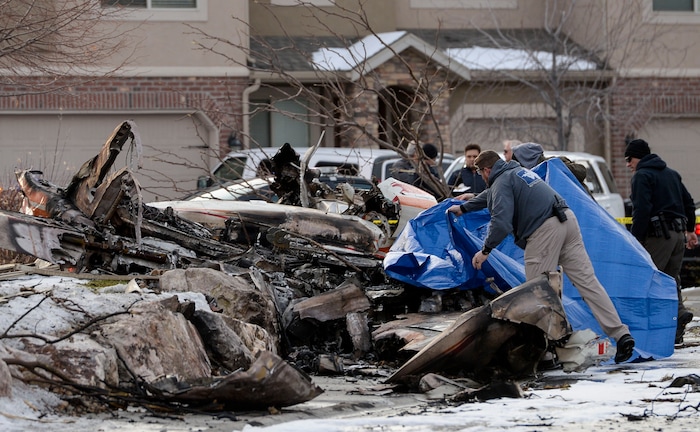 (Leah Hogsten | The Salt Lake Tribune) Weber County emergency personnel and firefighters work the scene of a small, private plane that crashed in a residential neighborhood in Roy, Jan. 15, 2020. A 64-year-old pilot was killed.