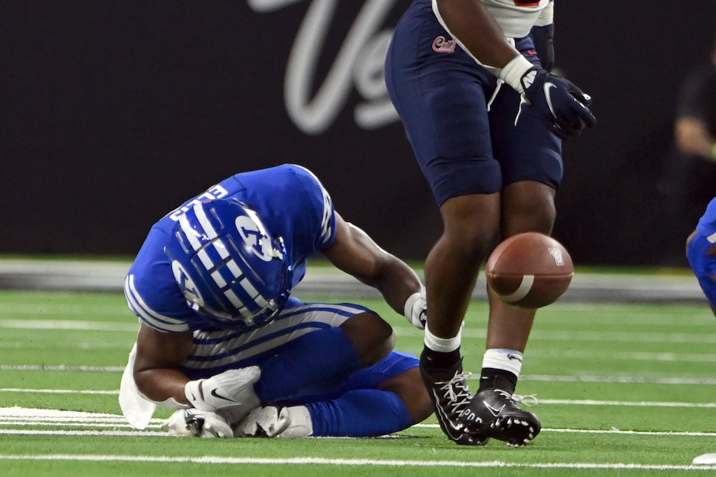 (David Becker | AP) BYU defensive back Keenan Ellis reacts to an apparent injury after defending against Arizona running back Michael Wiley during the first half of an NCAA college football game Saturday, Sept. 4, 2021, in Las Vegas.