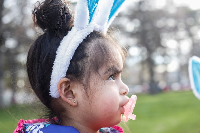 (Nicole Boliaux | For The Tribune) Perla Ramirez dons a pair of bunny ears and pacifier during the annual Easter egg hunt put on by A Kid's Place Dentistry in Liberty Park in Salt Lake City on Saturday, March 31, 2018.