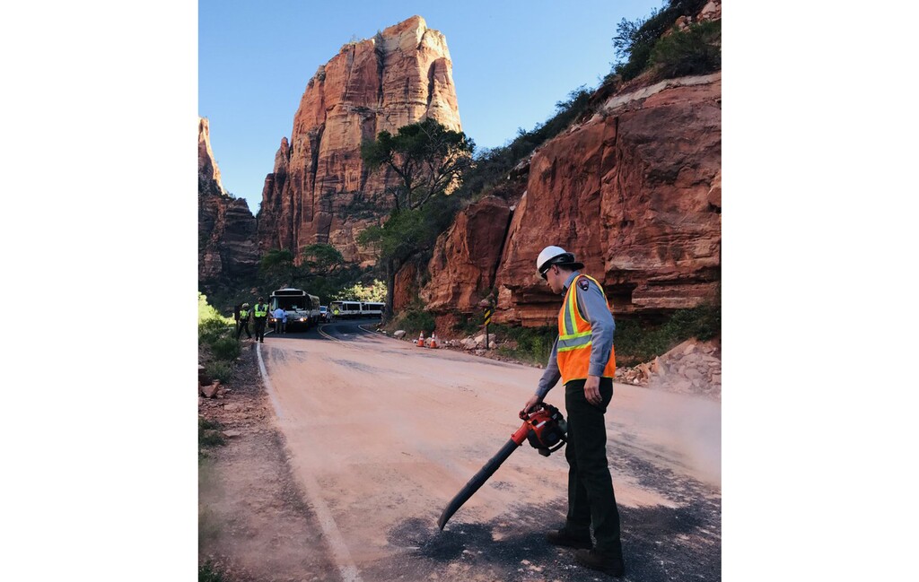 (Zion National Park via Twitter) Crews clean up the scene drive in Zion National Park after a rockfall Tuesday morning.
