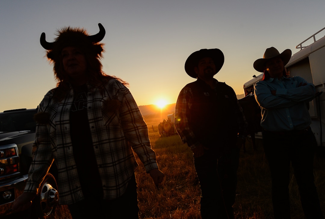 (Francisco Kjolseth  |  The Salt Lake Tribune)  KyAnn Betz, left, wears her bison hat at first light as she joins John and Angie Peek for the 33rd annual roundup, Saturday, Oct. 26, 2019, on Antelope Island, a state park located near Syracuse in Davis County. Every year Utah wildlife and parks officials move the animals from across the island so they can be weighed, tagged and given health screenings.