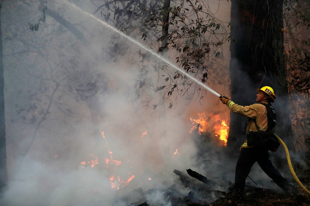 (Marcio Jose Sanchez | The Associated Press) Firefighter Ruben Mercado from engine 13 crew out of Burbank, Calif., battles a wildfire Saturday, Oct. 14, 2017, in Santa Rosa, Calif.