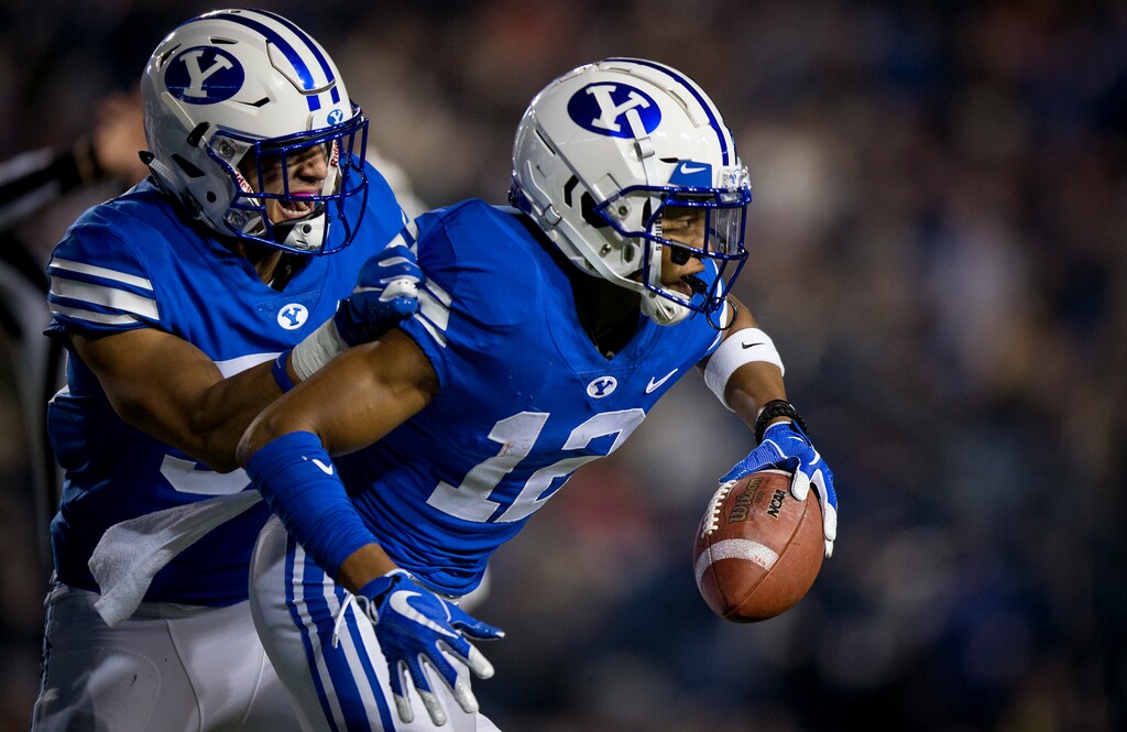 BYU linebacker Isaiah Kaufusi (53) and defensive back Malik Moore (12) celebrate Moore's interception against New Mexico State during an NCAA college football game Saturday, Nov. 17, 2018, in Provo, Utah. (Isaac Hale/Daily Herald via AP)