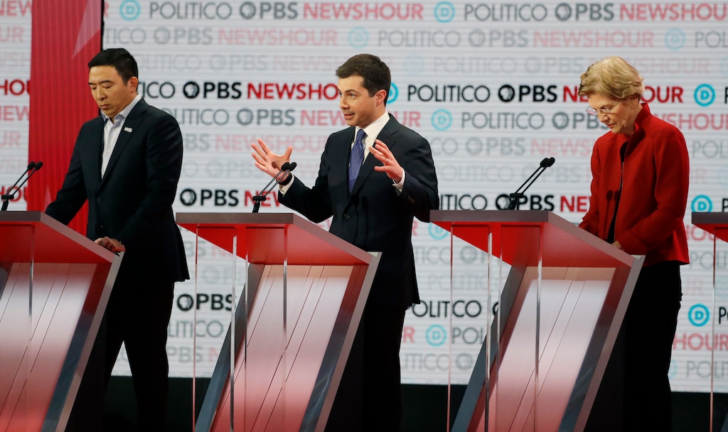 (Chris Carlson | AP) Democratic presidential candidate South Bend Mayor Pete Buttigieg, center, speaks beside entrepreneur Andrew Yang, left, and Sen. Elizabeth Warren, D-Mass., during a Democratic presidential primary debate Thursday, Dec. 19, 2019, in Los Angeles.