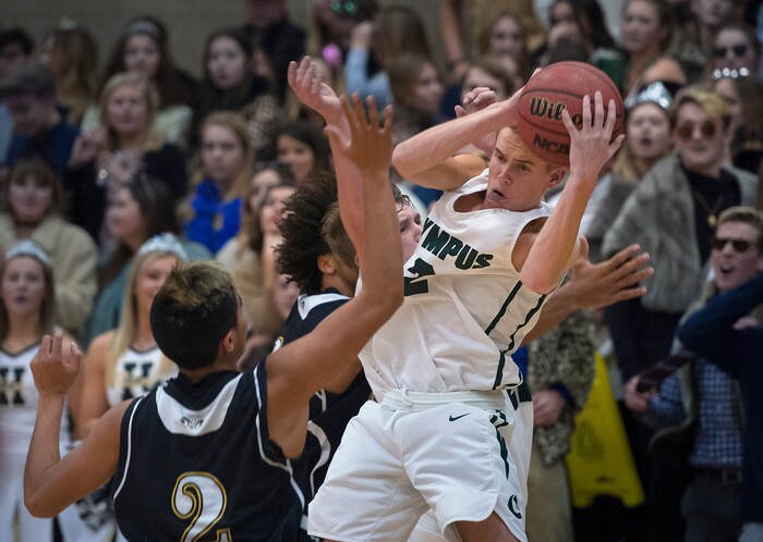 (Scott Sommerdorf   |  The Salt Lake Tribune)   Jacob Dowdell rips down a rebound during second half play as Olympus defeated Highland 70-49, Friday, January 19, 2018.