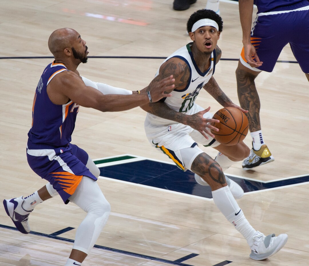 (Rick Egan | The Salt Lake Tribune)  Utah Jazz guard Jordan Clarkson (00) looks for a shot as Phoenix Suns guard Jevon Carter (4) defends, in preseason NBA action between Utah Jazz and Phoenix Suns at Vivint SmartHome Area, on Saturday, Dec. 12, 2020.
