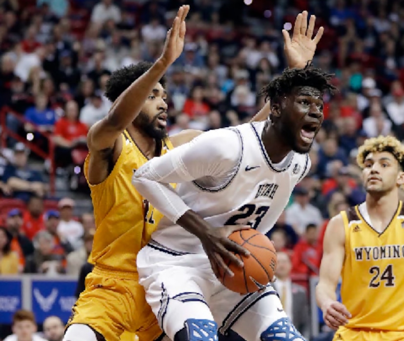 Utah State's Neemias Queta (23) pulls down a rebound as Wyoming's Trevon Taylor, left, defends during the first half of an NCAA college basketball game in the Mountain West Conference men's tournament Friday, March 6, 2020, in Las Vegas. (AP Photo/Isaac Brekken)