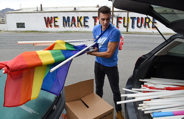 (Francisco Kjolseth | The Salt Lake Tribune) Ballet West dancer Lucas Horns gathers gay pride flags from his car as part of a service project to convert them over to transgender pride flags for the upcoming Transgender Day of Remembrance on Nov. 20. Horns who volunteers at the VOA Youth Resource Center, where he leads an LGBTQ support group, involves homeless youth through discussion and service projects. With their help Horns goal was to transfer 500 flags that would be placed from Ogden to Provo.
