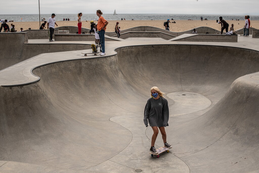 (Bryan Denton | The New York Times) Skateboarding, with a face mask, in the Venice beach area of Los Angeles, on Wednesday, June 24, 2020. Younger people are making up a growing percentage of new coronavirus cases in cities and states where the virus is now surging, a trend that has alarmed public health officials and prompted renewed pleas for masks and social distancing.