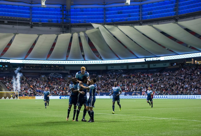 Vancouver Whitecaps' Bernie Ibini, Tim Parker, top, Kendall Waston and Fredy Montero. from left, celebrate Waston's goal against Real Salt Lake during the second half of an MLS soccer match Saturday, Sept. 9, 2017, in Vancouver, British Columbia. (Darryl Dyck/The Canadian Press via AP)