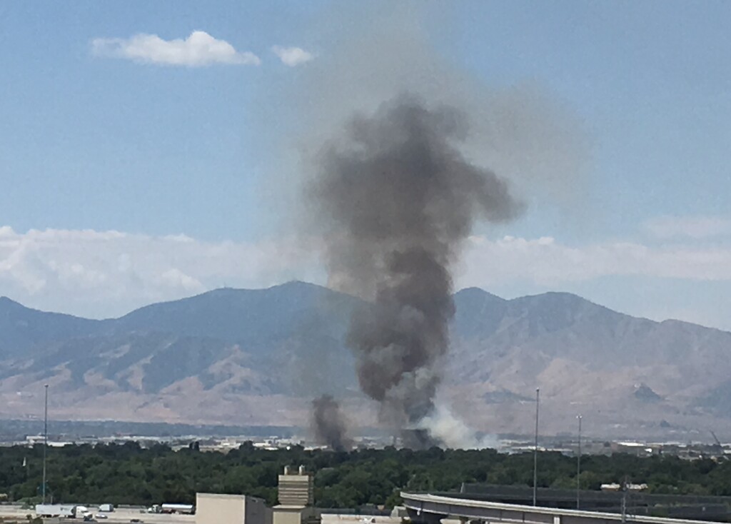 (Sean P. Means  |  The Salt Lake Tribune) The smoke plume from a grass fire around 1900 West and 800 South in Salt Lake City on Wednesday, July 25, seen from The Gateway downtown.
