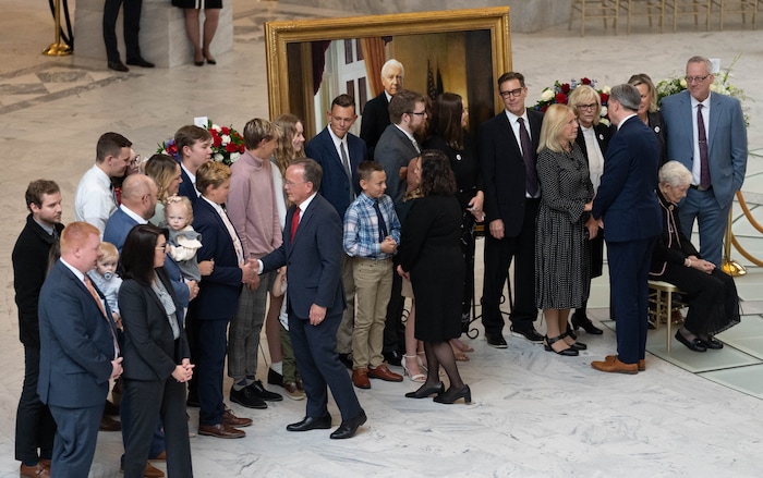 (Francisco Kjolseth | The Salt Lake Tribune) Lt. Gov. Deidre Henderson, Utah Senate President Stuart Adams and state treasurer Marlo Oaks greet the family after placing a wreath alongside the casket carrying former U.S. Sen. Orrin Hatch during a public viewing at the Utah Capitol on Wednesday, May 4, 2022.