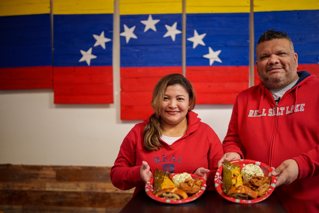 (Trent Nelson | The Salt Lake Tribune) Patricia Quiñonez and Fabian Rapalino with the Venezuelan food they'll be having this holiday season, at Arempa's in Salt Lake City on Wednesday, Dec. 22, 2021. On the plate, hallaca (wrapped meat and dough), pernil (slow-roasted pork), cachito (bread and ham), and a potato chicken salad.