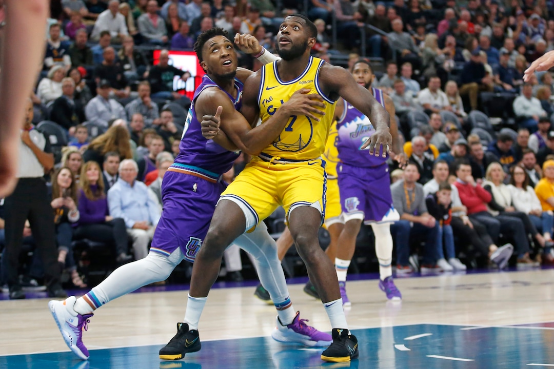 Utah Jazz guard Donovan Mitchell, left, guards Golden State Warriors forward Eric Paschall (7) in the first half during an NBA basketball game Friday, Nov. 22, 2019, in Salt Lake City. (AP Photo/Rick Bowmer)
