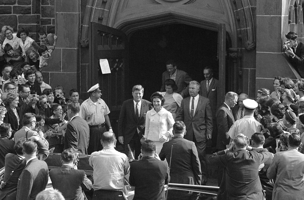 FILE - In this Oct. 1, 1961 file photo, President John F. Kennedy and first lady Jacqueline Kennedy leave St. Mary's Church in Newport, R.I., after Mass. The Rhode Island church, where the Kennedys wed on Sept. 12, 1953, is inviting visitors in to kneel where the couple knelt, listen to the music that played and imagine the day. (AP Photo/File)