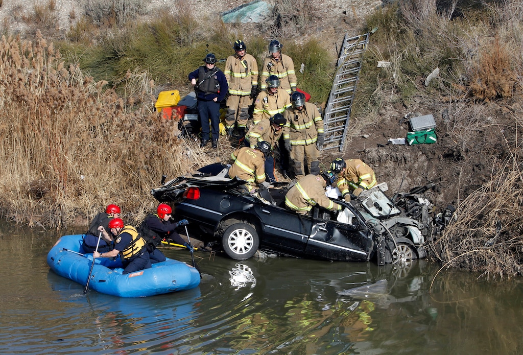 Rick Egan   |  The Salt Lake TribuneFirefighters work to remove the body of the driver of a car that flew over the pond from the off ramp from I-15 to 2100 South, and and smashed into the embankment on the other side.  Friday, January 28, 2011 The driver was killed in the accident, crews searched the water, but no other known passengers were in the vehicle